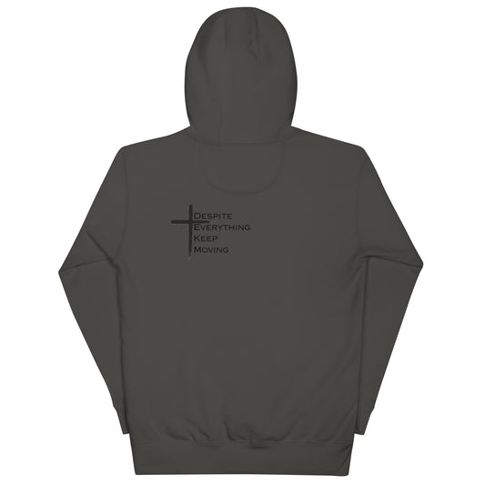 Back view of Vintage Black DEKM Block Buttersoft Hoodie featuring a black cross design with the text "Despite Everything Keep Moving" printed below it.