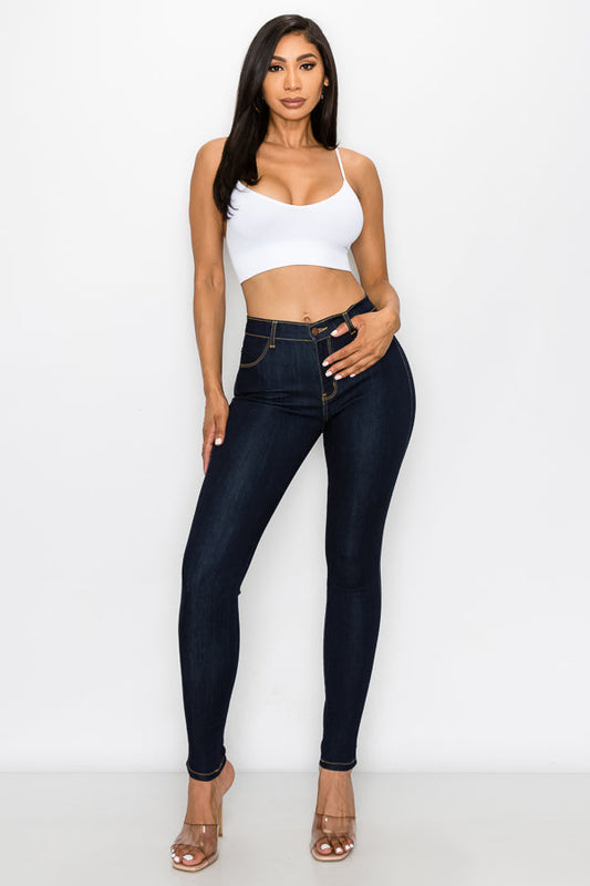 Dark blue jeans and a white top on a white background